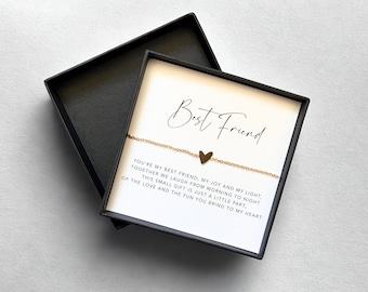 May include: A gold-colored heart charm bracelet presented in a black gift box. The box contains a card with the words "Best Friend" and a heartfelt message. A thoughtful gift for a friend.