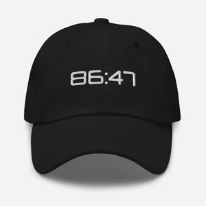 May include: Black baseball cap with white embroidered text that reads "86:47".