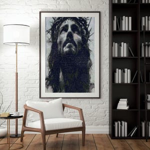 May include: Framed black and white artwork depicting a portrait of Jesus wearing a crown of thorns. The artwork is displayed in a room with a white brick wall, a wooden chair with a white cushion, and a floor lamp.