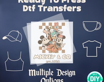 May include: A clear sheet of DTF transfer paper with a design featuring Mickey Mouse, Minnie Mouse, Donald Duck, Goofy, and Pluto. The design includes the text "Mickey & Co. Est. 1928".