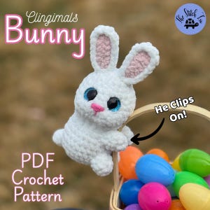 May include: A white crochet bunny with blue eyes, pink nose, and inner ears, holding onto a basket of colorful Easter eggs. The text "Clingimals Bunny" and "PDF Crochet Pattern" are visible.