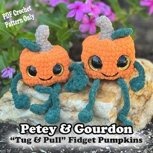 May include: Two orange crochet pumpkins with green stems and legs, and large, glittery eyes. The pumpkins have smiling faces and are labeled "Petey & Gourdon" and "Tug & Pull" Fidget Pumpkins. The text "PDF Crochet Pattern Only" is also visible.
