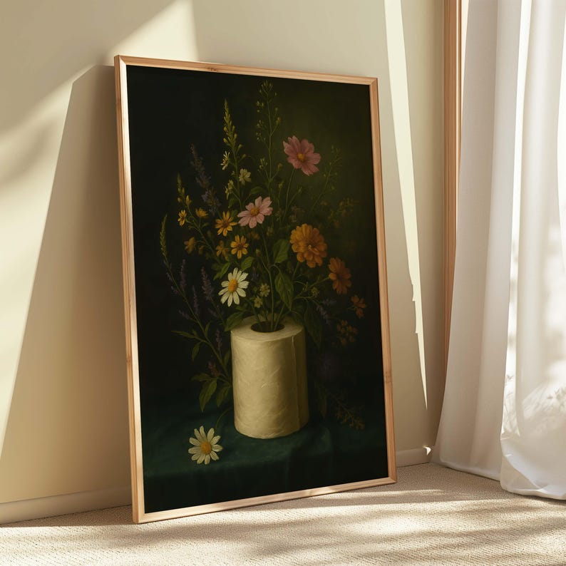 Puede incluir: Una impresi&oacute;n art&iacute;stica enmarcada que presenta un bodeg&oacute;n de flores coloridas dispuestas en un rollo de papel higi&eacute;nico. Las flores incluyen margaritas y lavanda sobre un fondo oscuro. La obra de arte tiene una est&eacute;tica vintage.