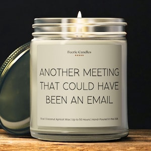May include: A clear glass jar candle with a white label featuring the text "Feerie Candles" and "ANOTHER MEETING THAT COULD HAVE BEEN AN EMAIL". The label also states "9 oz | Coconut Apricot Wax | Up to 50 Hours | Hand-Poured in the USA".