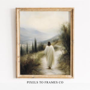 May include: Framed art print depicting a figure in a white robe walking on a path, with a scenic landscape of mountains and trees in the background. The artwork is in a gold-colored frame, with the text "PIXELS TO FRAMES CO" at the bottom.