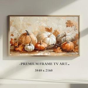Puede incluir: Una obra de arte enmarcada que presenta una naturaleza muerta de calabazas en tonos naranja, blanco y gris, con hojas de otoño. El texto "-PREMIUM FRAME TV ART-" y las dimensiones 3840 x 2160 son visibles.