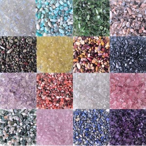 May include: Assortment of 12 small bags of colorful tumbled stones, including amethyst, rose quartz, clear quartz, green aventurine, blue lapis lazuli, and more.