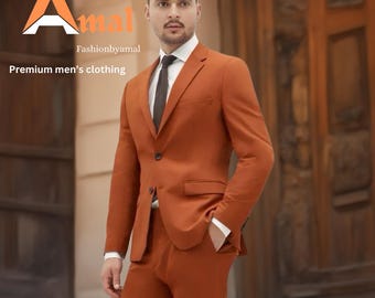 May include: A rust-colored suit with a black tie and white dress shirt. The suit jacket has a single button closure. The image includes the text "amal" and "Fashionbyamal" with the words "Premium men's clothing".