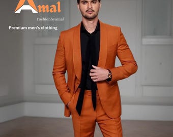 May include: An orange suit with a black shirt and tie. The suit is a solid color and appears to be made of a textured fabric. The image includes the text "Amal" and "Fashionbyamal" and "Premium men's clothing".