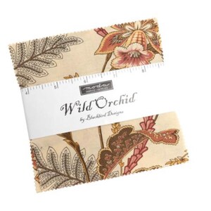 May include: A stack of fabric squares with a floral pattern in shades of beige, brown, and red. The fabric is labeled "Wild Orchid" by Blackbird Designs, with a ruler printed on the label. The fabric squares are approximately 6 inches by 6 inches.