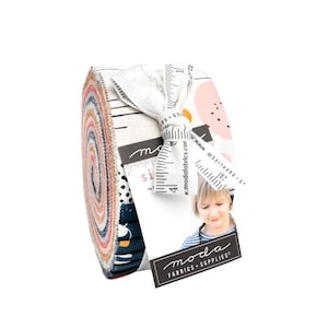 May include: A fabric roll featuring a variety of colorful patterns, including dots, lines, and floral designs. The roll is tied with a white ribbon printed with ruler markings and a tag with the "moda FABRICS + SUPPLIES" logo.