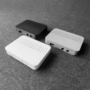 May include: Three Raspberry Pi cases in black, white, and gray. Each case has a patterned design of small holes for ventilation.