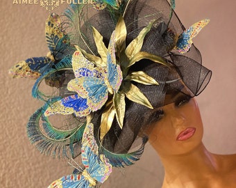 Sombrero Aimee Fuller Kentucky Derby, tocado negro y azul, enormes plumas de pavo real, mariposas doradas y verde azuladas, Copa Del Mar Races Melbourne