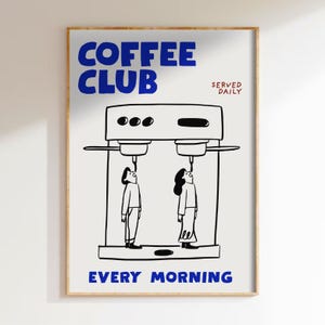 May include: A framed art print with a coffee theme. The words "COFFEE CLUB" in blue are at the top, with "SERVED DAILY" in red. Below is a black and white illustration of a coffee machine with two people looking up at it. The words "EVERY MORNING" are at the bottom.