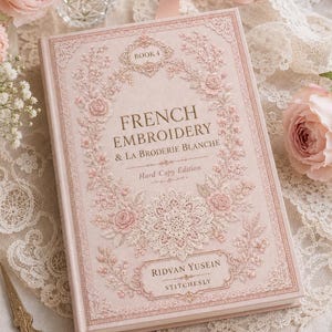 May include: A hardcover book titled French Embroidery & La Broderie Blanche Book 4 by Ridvan Yusein. The cover is light pink with intricate floral and lace-like embroidery patterns in shades of pink and white, featuring ornate decorative borders.