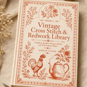 May include: A hardcover book titled Vintage Cross Stitch & Redwork Library Book 3 by Ridvan Yusein, featuring a cream cover with red ink illustrations of a rooster, a teapot, and floral motifs, surrounded by embroidery scissors and thread.