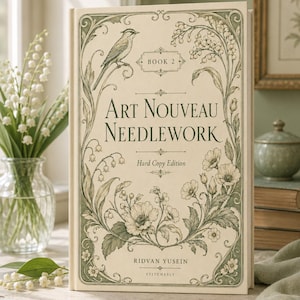 Könnte beinhalten: Ein gebundenes Buch mit dem Titel Art Nouveau Needlework Book 2 von Ridvan Yusein. Der cremefarbene Einband zeigt detaillierte grüne botanische Illustrationen von Blumen und einem Vogel, mit dekorativen Rändern und dem Text Hard Copy Edition.