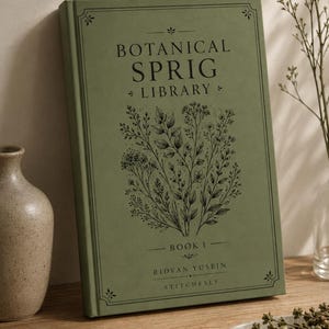 May include: A sage green hardcover book titled Botanical Sprig Library Book 1 by Ridvan Yusein Stitchesly. The front cover features a black line art illustration of various botanical sprigs and leaves, enclosed within a decorative border.