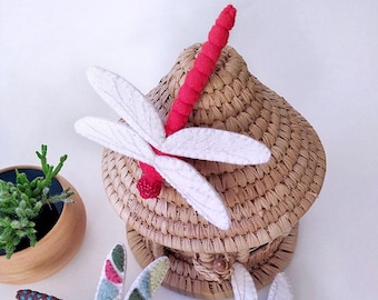 May include: Three felt dragonfly ornaments in different colors and patterns. One dragonfly is red and white, one is green and white with colorful accents, and one is white with a green body.