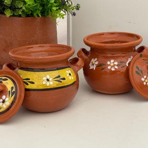 May include: A set of three ceramic mugs with a speckled, matte finish. The mugs are in shades of cream, light gray, and dark gray. Each mug has a simple, minimalist design, perfect for coffee or tea.