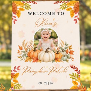 May include: A rectangular sign on a wooden easel featuring the text WELCOME TO, Olua's, and Pumpkin Patch with the date 08 | 28 | 26. The design includes a central photo of a baby, surrounded by illustrations of orange and white pumpkins and autumn leaves.