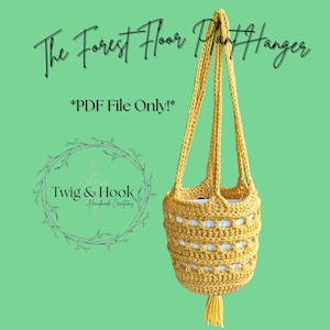 May include: A handmade yellow crochet plant hanger with a tassel, designed to hold a small plant. The text "The Forest Floor Plant Hanger" and "*PDF File Only!*" are displayed on a green background. The Twig & Hook logo is also visible.