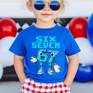 May include: A blue t-shirt with the words "SIX SEVEN" in pixelated font. Below the text are the numbers 6 and 7 designed as cartoon characters with arms, legs, and shoes. The child is wearing sunglasses and red and white checkered shorts.