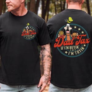 May include: Black t-shirt featuring a cartoon character holding a burger and fries, with the text "Dad Tax" in red script. The phrase "If I'm buyin', I'm tryin'" is also included in the design. The design is on the front and back.