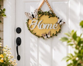 Vit och gul fjärilsdörrhängare HOME, väggkonst