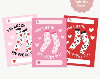 May include: Three Valentine's Day cards with a sock design and the text "You knock my socks off!"  The cards are pink, red, and white with hearts and a "to:" line at the top.