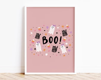 May include: Pink printable Halloween art print with ghosts, black cats, and candy corn. The text "BOO!" is in the center of the print.