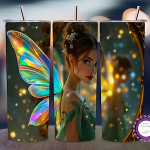 May include: A stainless steel tumbler featuring a fantasy illustration of a fairy with iridescent wings and a green dress. The design includes a blurred background with bokeh lights and a gold-framed mirror. The tumbler has a silver straw.
