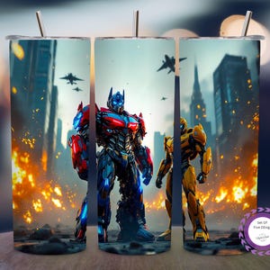 May include: Set of five stainless steel tumblers with a colourful design of Transformers characters in a city. The tumblers feature Optimus Prime and Bumblebee with skyscrapers, fighter jets, and explosions. Each tumbler includes a straw.
