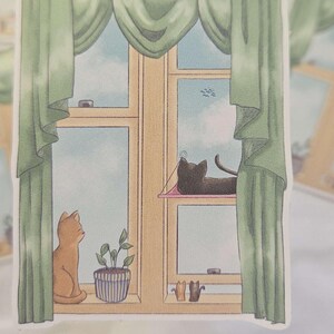 Des chats à la fenêtre