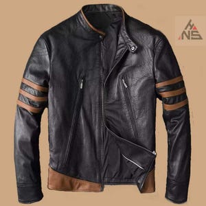 May include: Black leather jacket with brown accents on the sleeves and lower hem. The jacket features a stand-up collar, multiple zippered pockets, and a diagonal zipper closure. The sleeves have three brown stripes.
