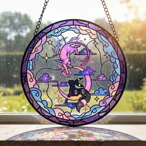 Może przedstawiać: Okrągłe witrażowe okno przedstawiające dwie postacie z kreskówek, jedną różową i jedną czarną, na tle chmur, gwiazd i półksiężyca. Okno ma ciemnofioletową obwódkę i jest zawieszone na łańcuchu.