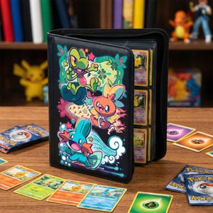 May include: Black zip-up trading card binder with vibrant cartoon characters. The binder is open, revealing card sleeves filled with cards. Several trading cards are scattered on the wooden surface, with figurines in the background.