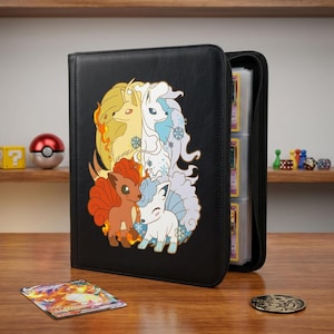 May include: A black zippered trading card binder featuring a graphic of four fox-like creatures in fire and ice themes. The cover displays two orange and two white characters surrounded by flames and snowflakes. The binder is partially open, showing card sleeves.