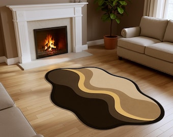 May include: A modern area rug with a unique, organic shape. The rug features a wavy design in shades of brown, tan, and gold, creating a warm and inviting aesthetic. The rug is placed on a hardwood floor, complementing the room's decor.
