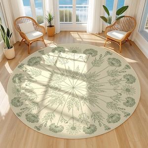 May include: A circular rug with a cream backdrop and a detailed floral design in green hues. The rug showcases a central starburst pattern with radiating stems and various flower and leaf illustrations. The rug is placed on a wooden floor.