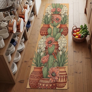 May include: A rectangular kitchen runner rug featuring a repeating pattern of cacti in terracotta pots with peach-colored flowers and green leaves. The rug has a light yellow background and is bordered by a brown geometric design.