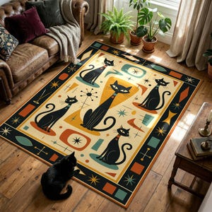 May include: A rectangular rug with a mid-century modern design. The rug features black cat illustrations with orange collars, set against a cream background with geometric shapes in orange, teal, and yellow. The border is black with starburst and diamond patterns.