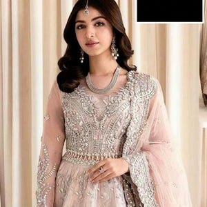 peach and silver dress Fully sequined dress of peach & shimmery silver with a high slit. The  embroidery is hugging the neckline with a playful intertwined criss-cross.  #TonyWardCouture #TonyWardRTWSS24 #TheOtherSideofEden