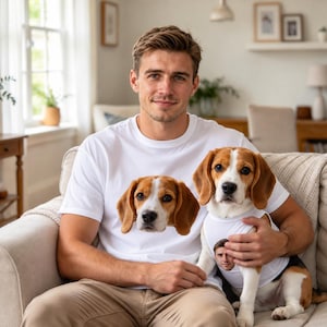 May include: A white t-shirt featuring a printed beagle dog face on the front, paired with a matching white dog tank top that displays a printed human face. The beagle dog is wearing the tank top, which features a portrait of the person wearing the t-shirt.