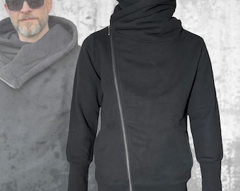 Sudadera con capucha de felpa negra: cremallera asimétrica, orificios para los pulgares, capucha grande y amplia.