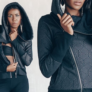 May include: A black hooded jacket with a geometric pattern. The jacket has a zipper closure and a high collar.