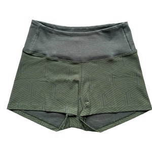 May include: Olive green athletic shorts with a geometric pattern on the lower portion and a solid gray waistband. The shorts are designed for comfort and movement, suitable for various fitness activities.