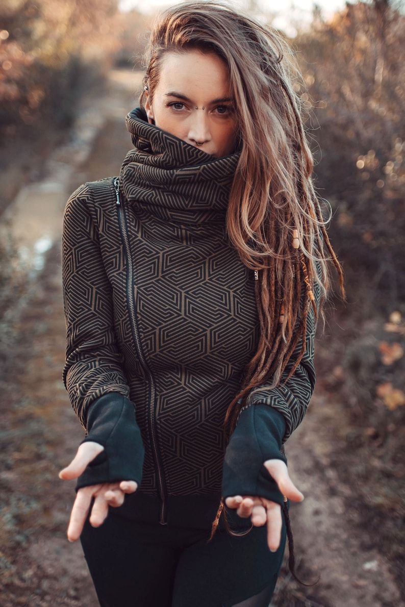 All-over printed warm fleece hoodie featuring a generous hood and geometric print with asymmetrical zipper. This essential winter jacket. Made from soft cotton fleece. Structured hood and snap closure collar. Combines style, warmth, and comfort!