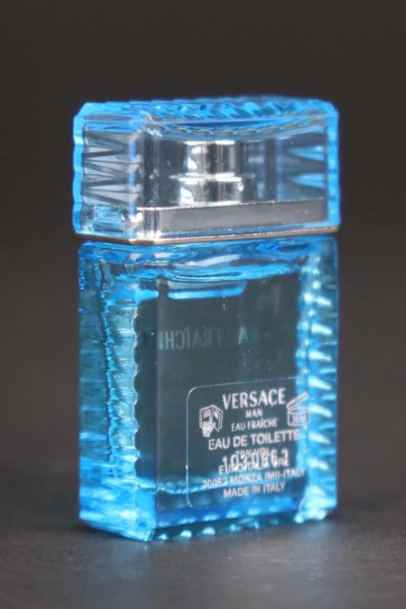 Puede incluir: Una taza de cer&aacute;mica blanca con un asa negra y el texto "But First, Coffee" en negrita negra. La taza se encuentra sobre un fondo borroso, sugiriendo un ambiente acogedor.