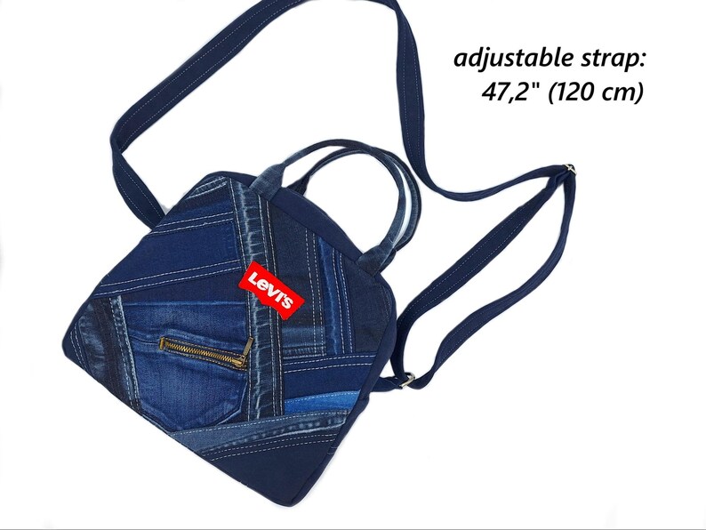 May include: A dark blue denim patchwork backpack featuring a red Levi's brand tag, two top handles, and an adjustable strap measuring 47.2 inches. The bag includes a front pocket with a gold-toned zipper closure and various shades of blue denim fabric.
